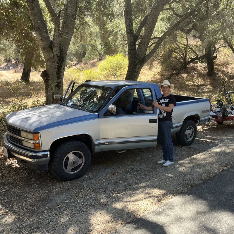 gus with the truck under oak trees