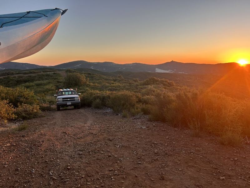 truck at sunset under a kayak