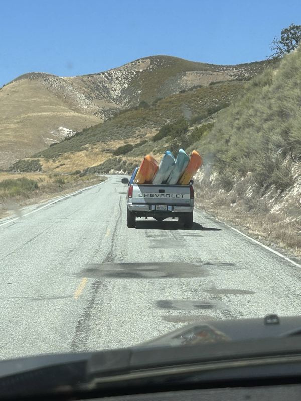 truck hauling kayaks up a highway